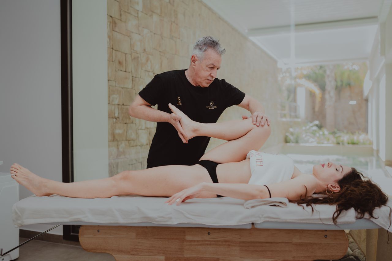 Mastering the First Impression: Your intriguing post title goes here A therapist assists a patient during a rehabilitation session indoors, promoting mobility and flexibility.